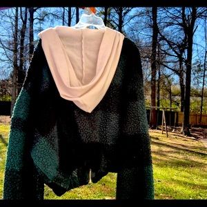 Green & black plaid zip-up jacket & white hoodie.